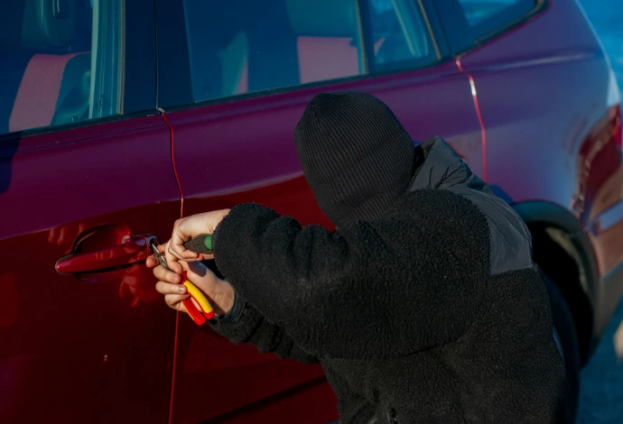 A person is trying to break into a car